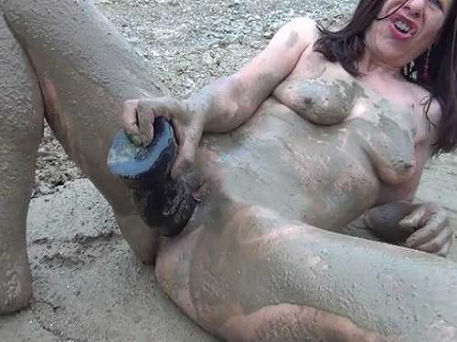 Dirty mature outdoor dildo fuck in the mud