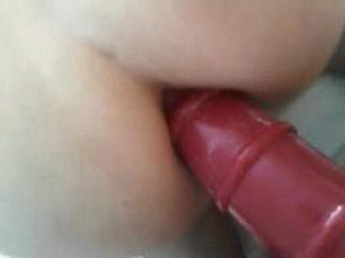 Giant red plug very close penetrated into wifes ass